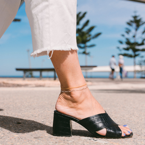 Girl wearing high heels shows 2 permanent anklets in Perth